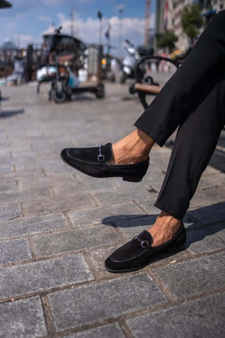 Classic Black Suede Bit Loafers for Office & Evening Wear – worn by a man in black trousers, with one foot lifted, showcasing versatile style for office to evening wear.