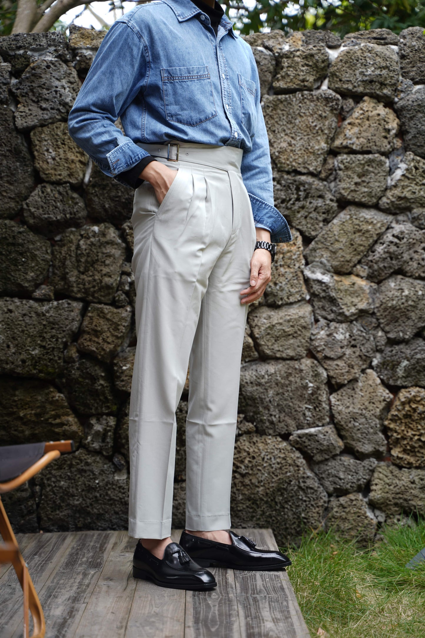 Elegant Hand-Made Black Leather Tassel Loafers – full-grain polished black leather, worn by a man in light trousers, showcasing classic tassel design.