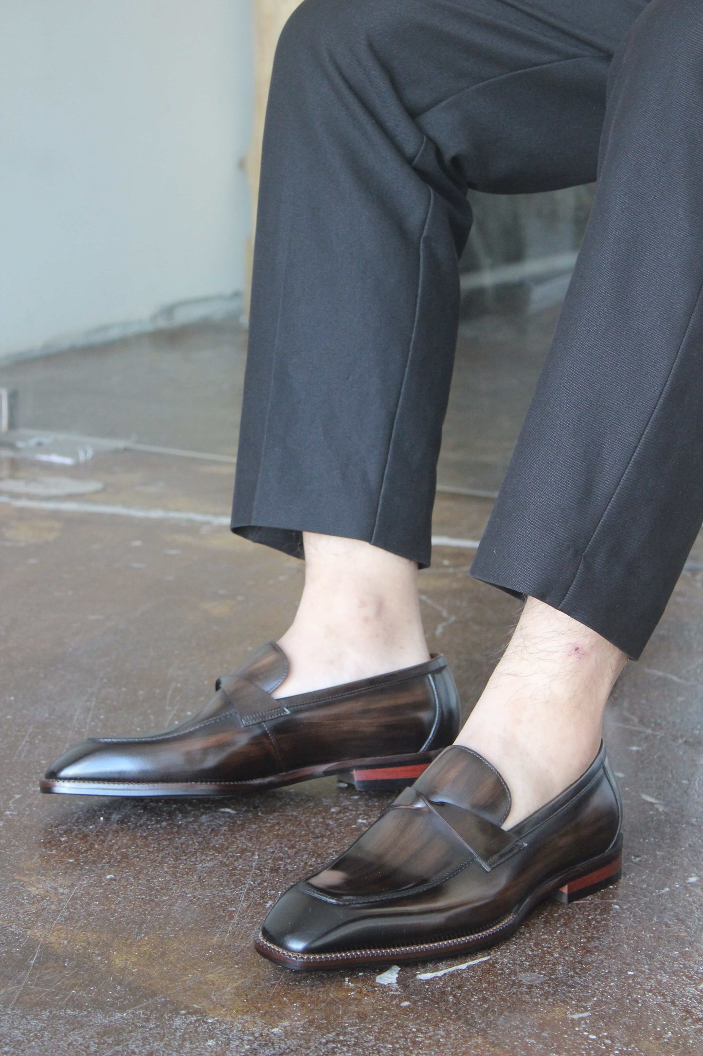Hand-Painted Dark Brown Leather Penny Loafers – worn by a man in black trousers, showcasing polished leather and sleek design.