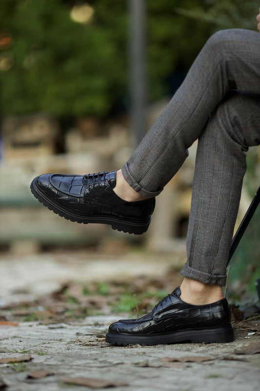Statement Black Crocodile Leather Derby Shoes – worn by a man in cuffed grey trousers, showcasing the unique crocodile pattern and versatile style