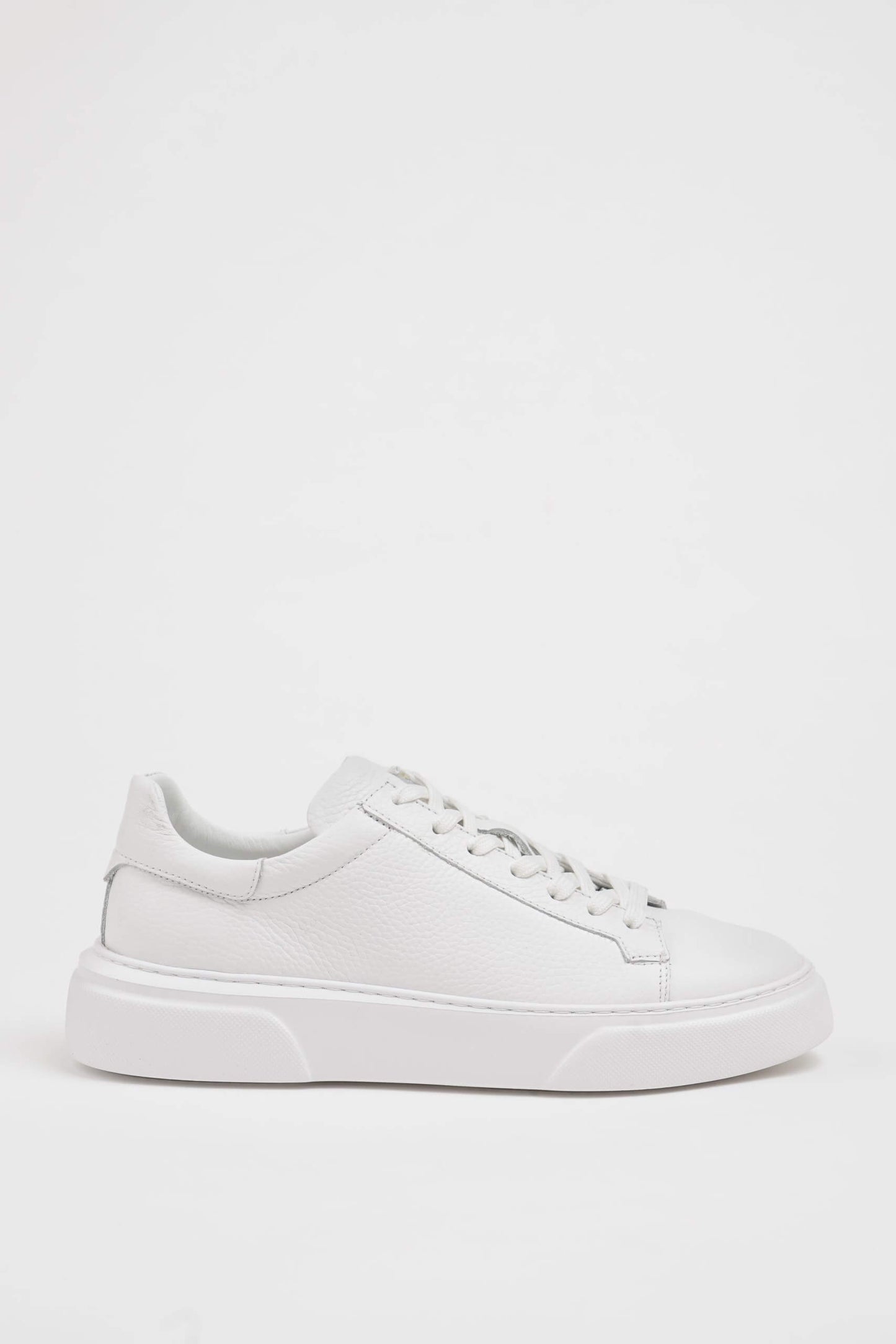 HolloShoe All White Grained Leather Sneaker - Minimalist Style – side view on white background, showcasing rich white leather and all-black sole.