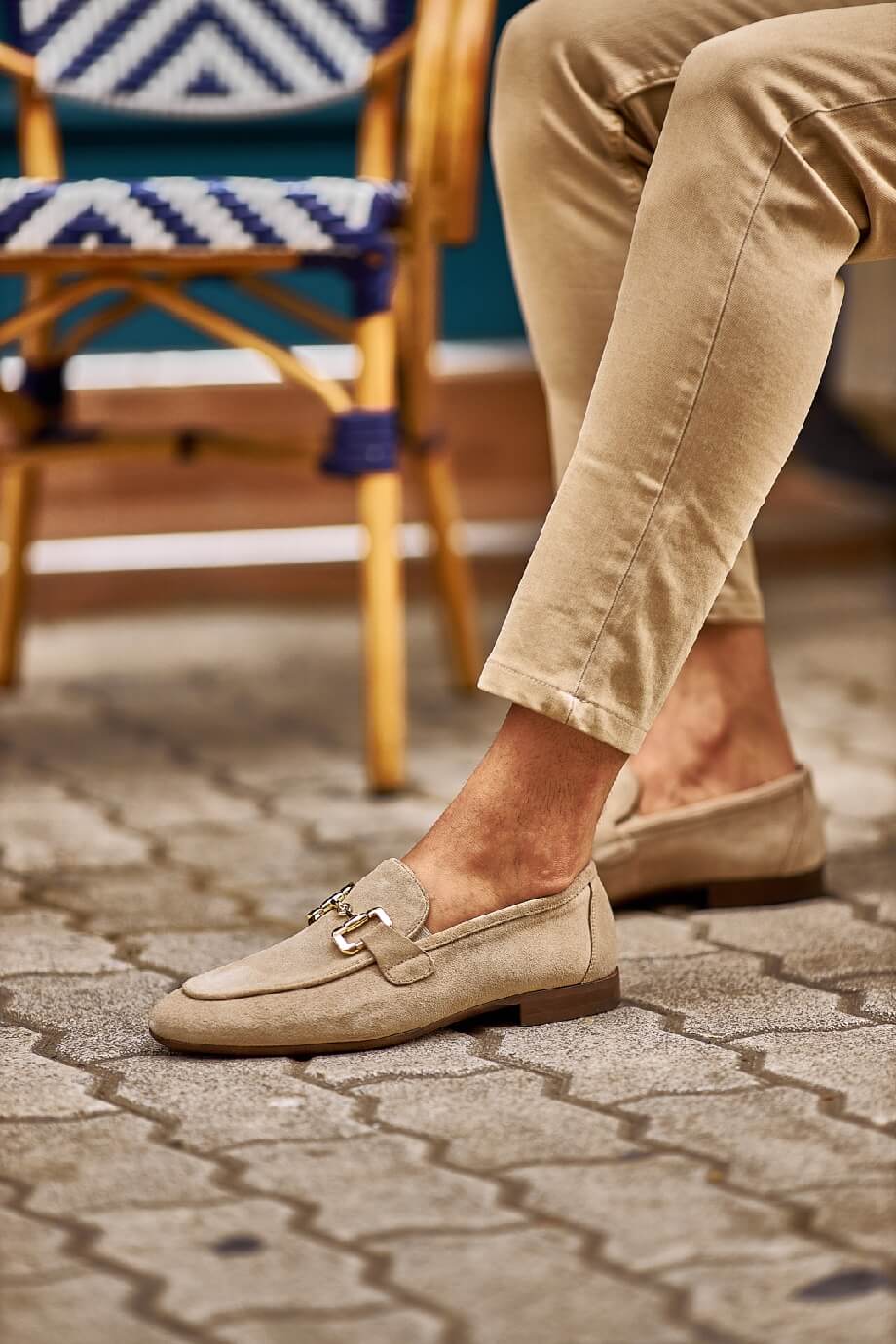 HolloShoe Beige Suede Horsebit Loafers for Stylish Men – worn by a man in tan chinos, sitting in a chair, highlighting timeless elegance and a refined aesthetic.