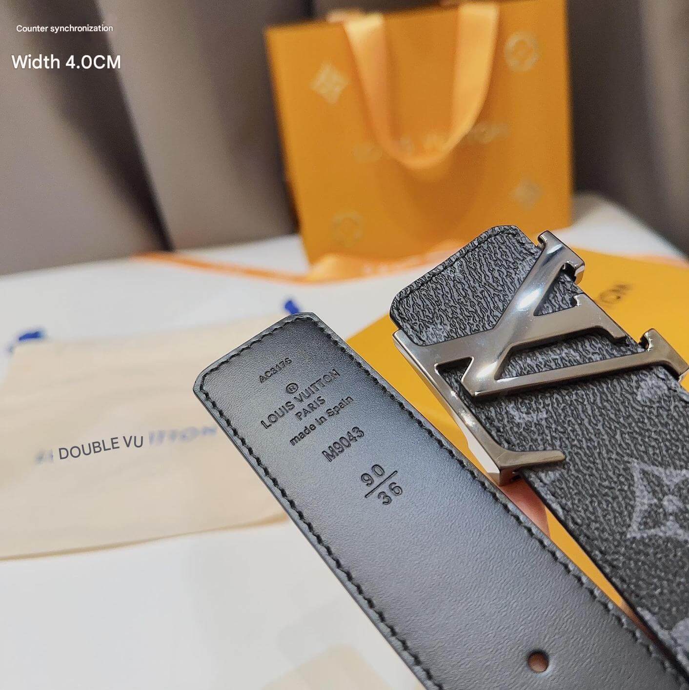 Gray leather belt with silver buckle on a blurred background