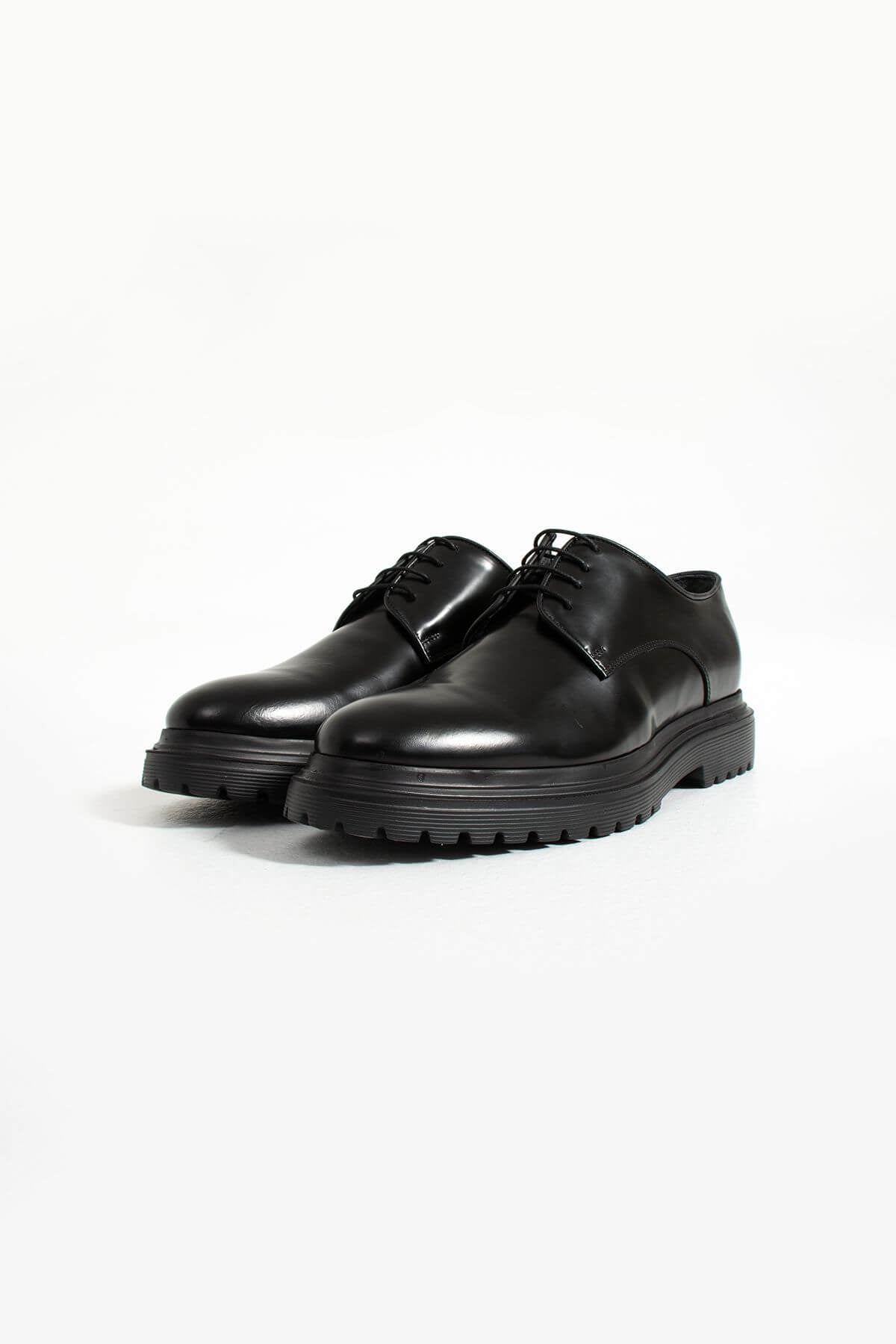 Pair of black leather shoes on a white background