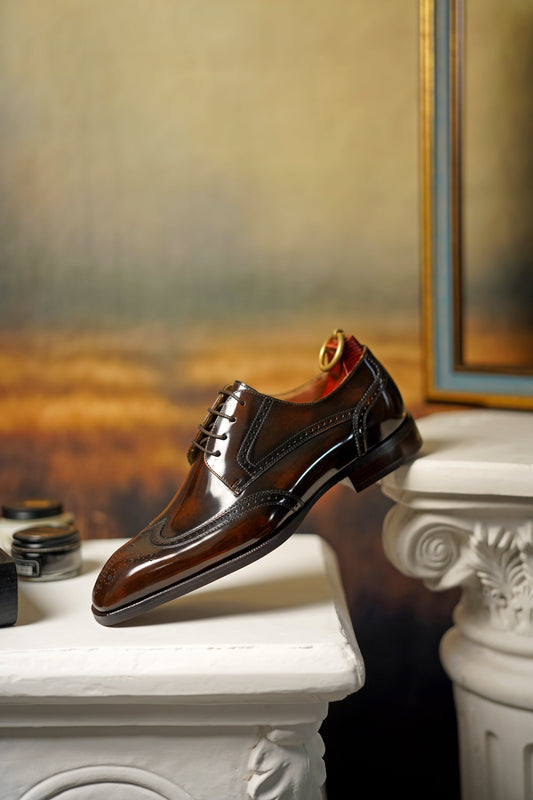 Exquisite Brown Wingtip Derby Shoes – premium cowhide leather, angled side view on a white pedestal, showcasing impeccable shine and brogue detailing.