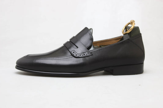 Refined Black Leather Penny Loafer – side view with shoe tree on white background, highlighting premium leather and sleek silhouette for versatile wear.