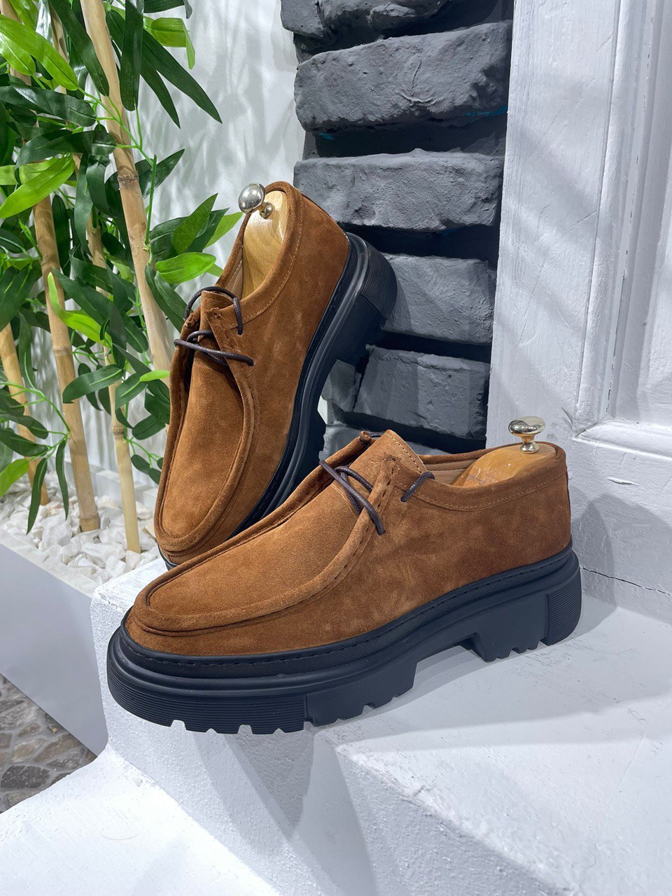 Stylish Tan Suede Lace-Up Chunky Shoes – urban footwear on a white ledge against a brick wall, with lace-up closure for secure fit.