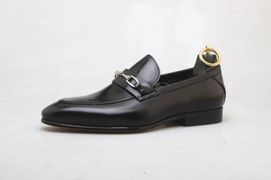 Sophisticated Black Leather Bit Loafer For Men – side view with a shoe tree, showcasing premium black leather, glossy finish, and distinctive metal buckle.