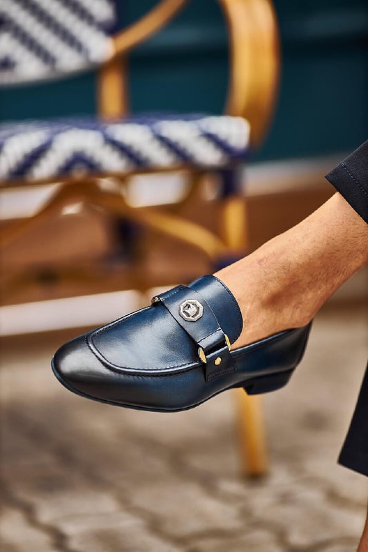 Sophisticated Navy Blue Leather Penny Loafer - Elegance Redefined – close-up on foot, highlighting high-quality leather, a sleek metal buckle, and a navy blue finish.
