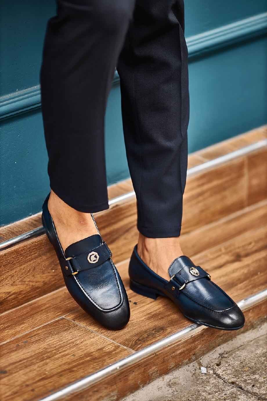 Sophisticated Navy Blue Leather Penny Loafers - Elegance Redefined – worn by a man in dark trousers, standing on wooden steps, showcasing timeless elegance and all-day comfort.