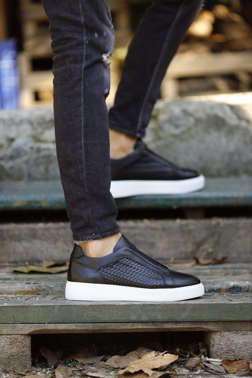 Special Design Black Straw Detail Leather Sneakers – worn by a man in distressed black jeans, walking up stairs, showcasing sleek design, superior craftsmanship and white sole.