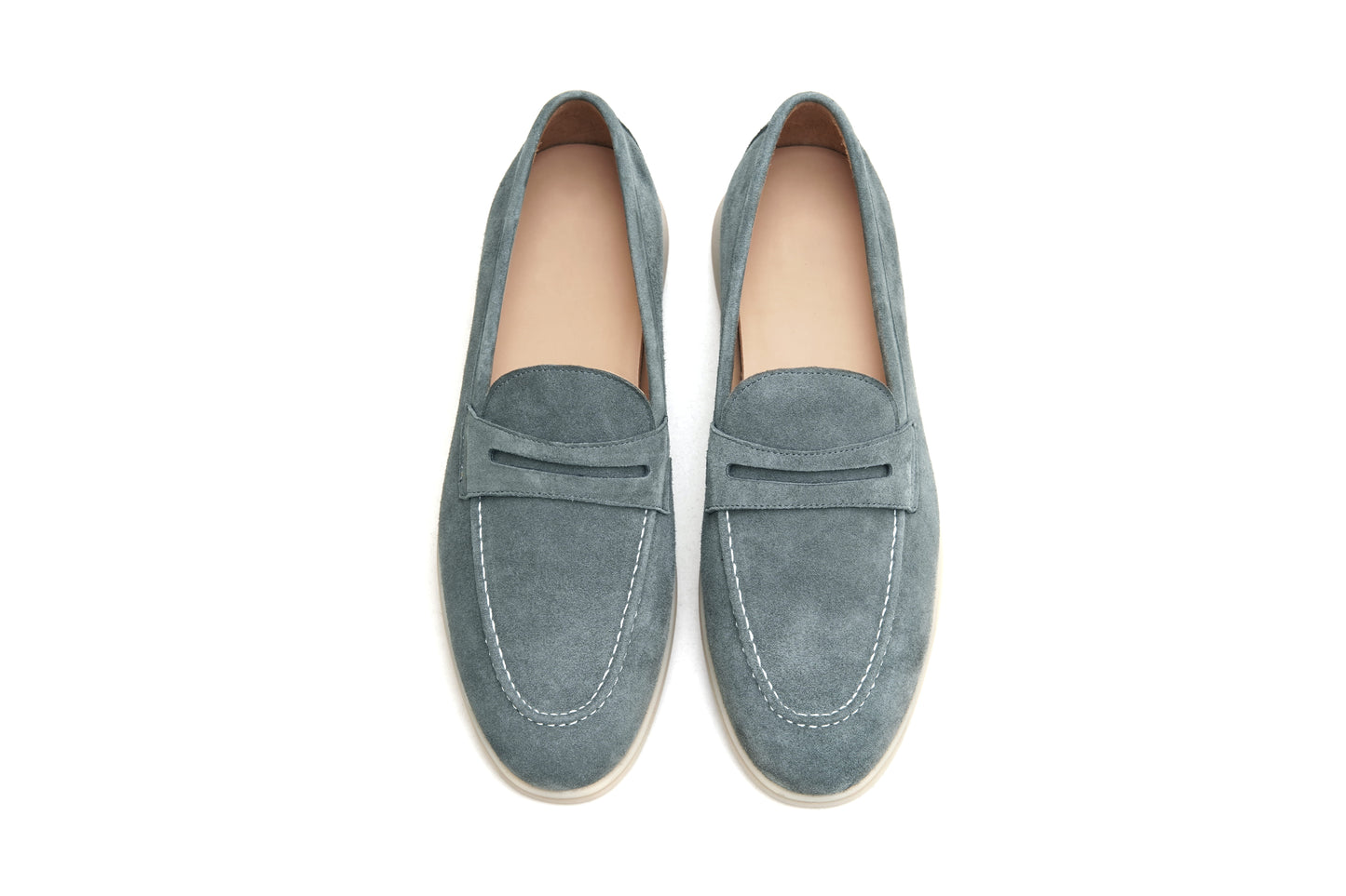 Pair of pale cyan suede penny loafers on white background, front view