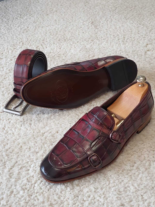 Claret Double Monk Strap Leather Loafers – pair with shoe trees and matching belt, showing side profile and outsole detail of luxurious red crocodile leather.