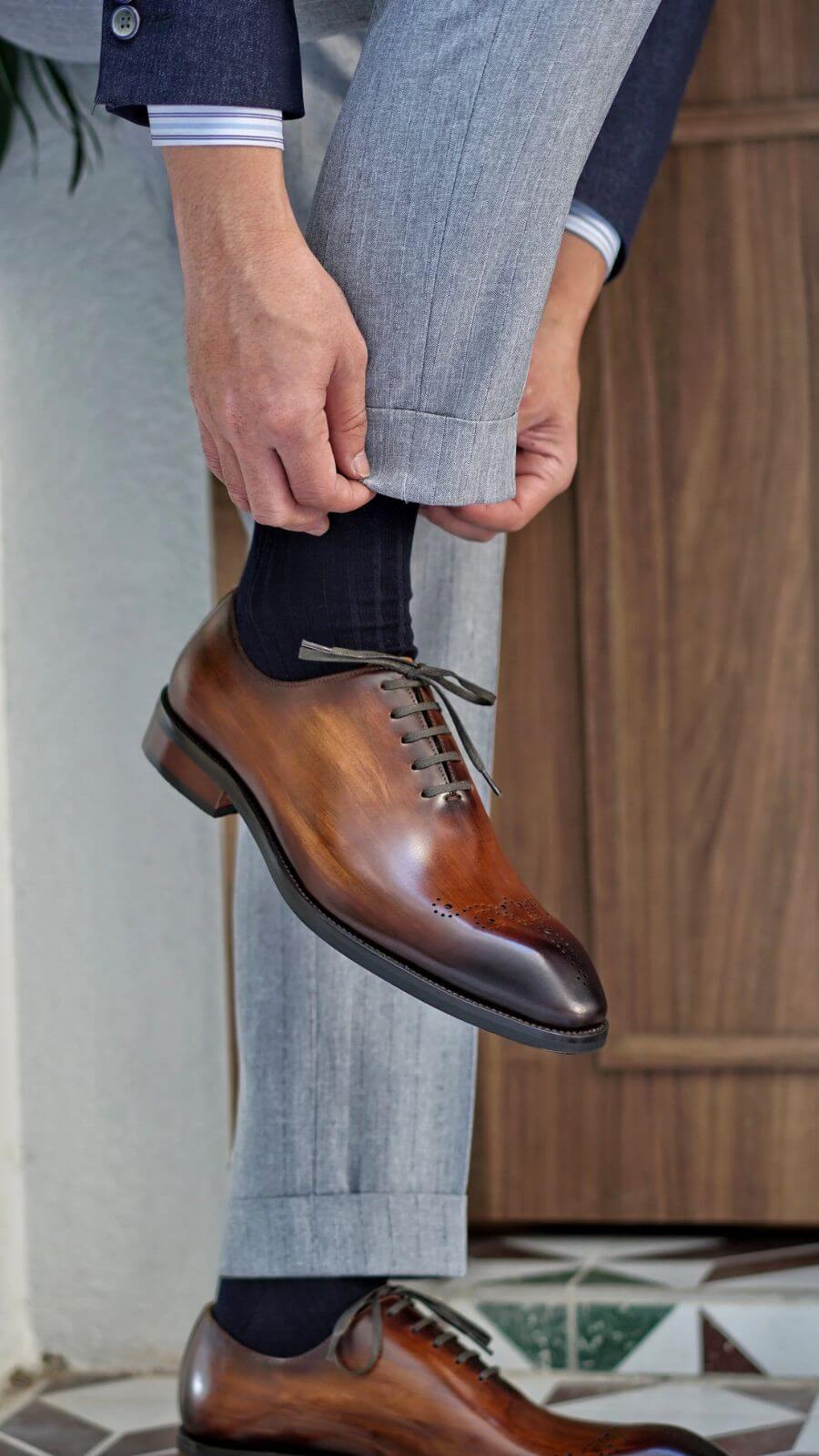 Chestnut brown leather wholecut oxford shoes on display