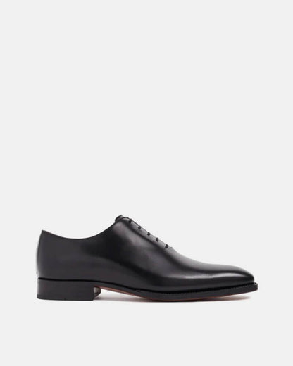 Men's black dress shoes, wholecut style on display