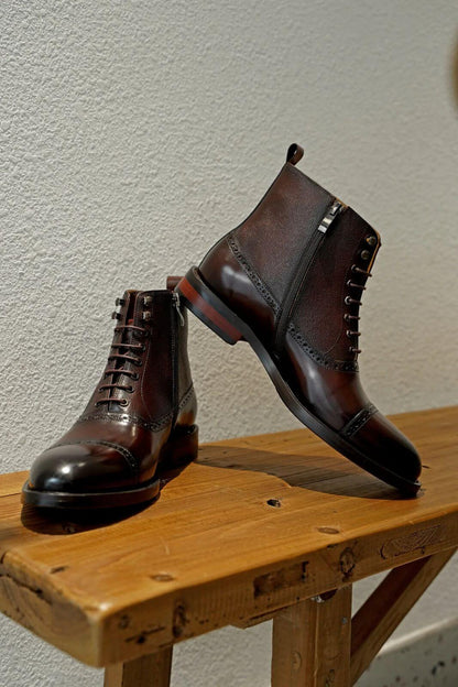 Men's brown leather combat boots on display