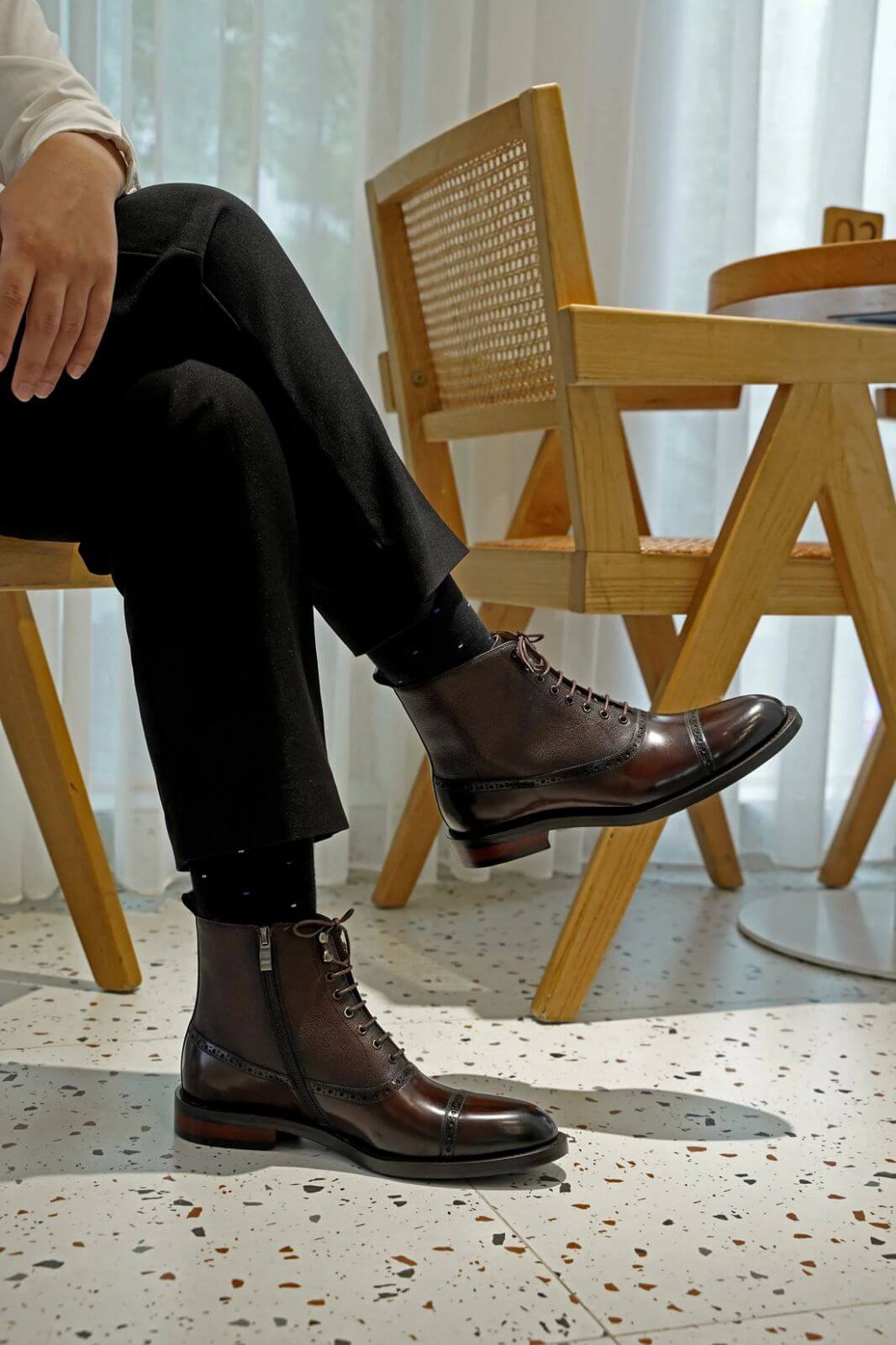 Men's brown leather combat boots on display