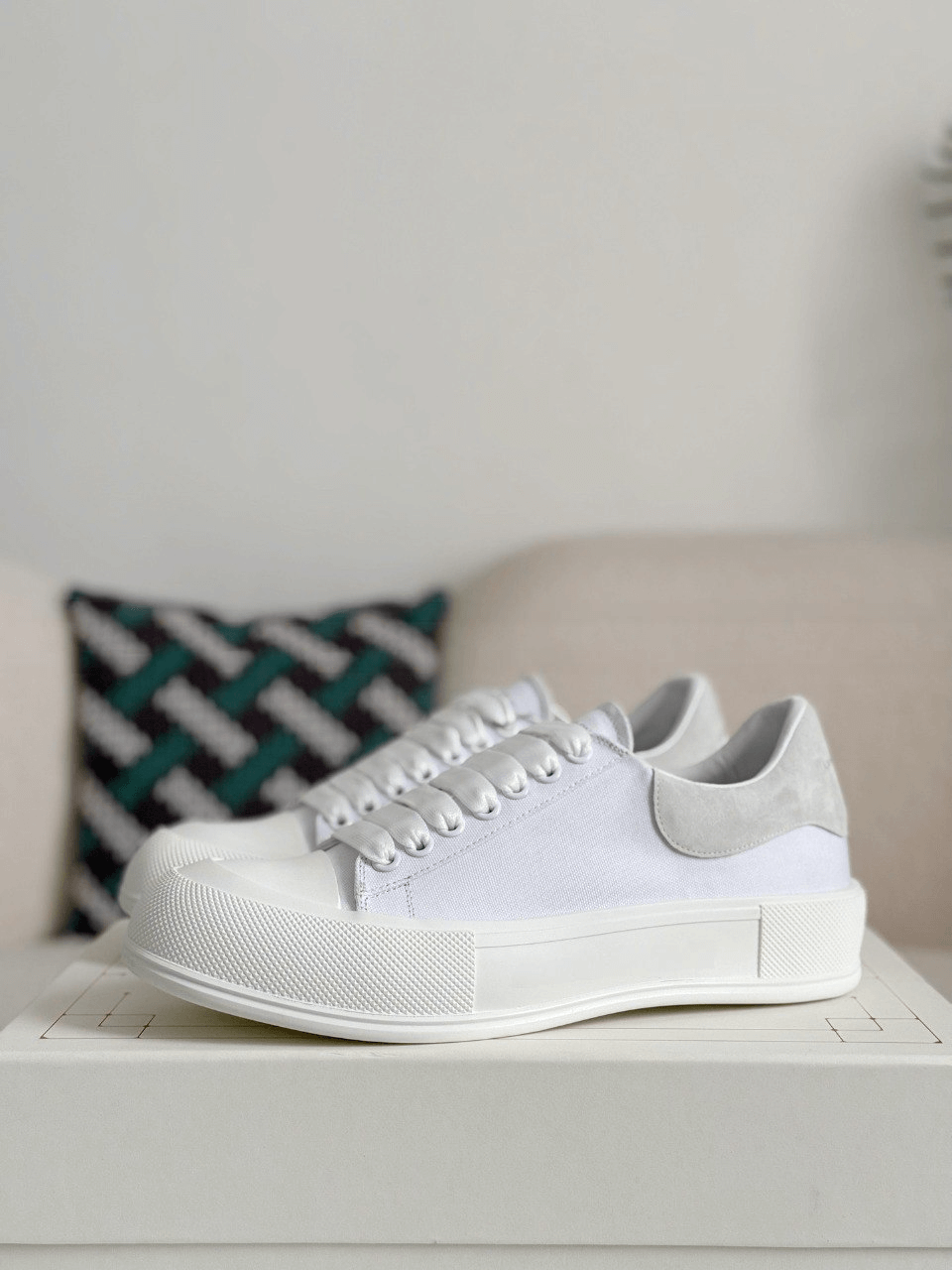 White sneakers on a white surface with a neutral background