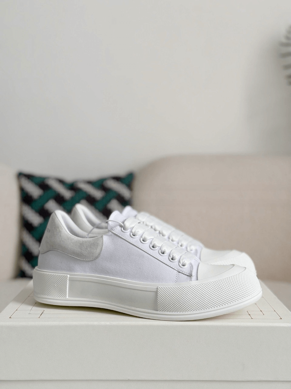 White sneakers on a white surface with a neutral background