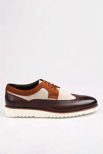 Side profile of fashionable brown leather brogue shoes with beige suede panels and a sturdy white sole, perfect for formal and casual wear