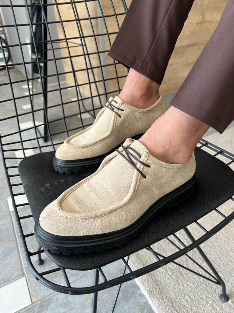 Beige Suede Lace-Up Shoes with Thick Soles – pair worn by a man in brown trousers, sitting on a metal chair, ideal for bold casual style.
