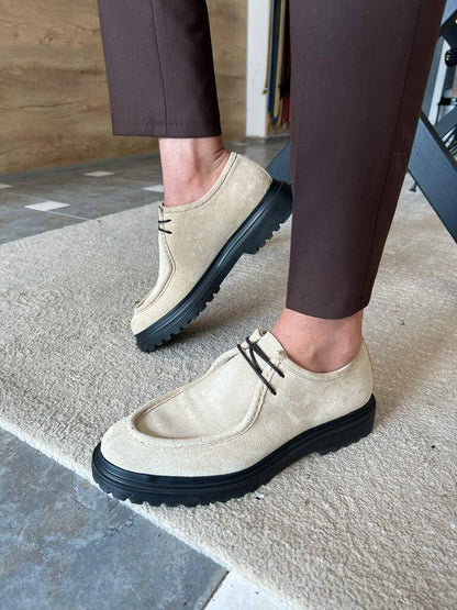 Beige Suede Lace-Up Shoes with Thick Soles – pair worn by a man in brown trousers, sitting on a metal chair, ideal for bold casual style.