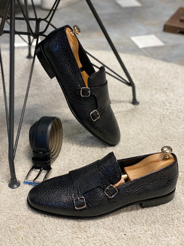 Black Grained Leather Double Monk Strap Shoes – pair with shoe trees and matching black belt, on a white rug, showcasing classic design and durable neolite sole.
