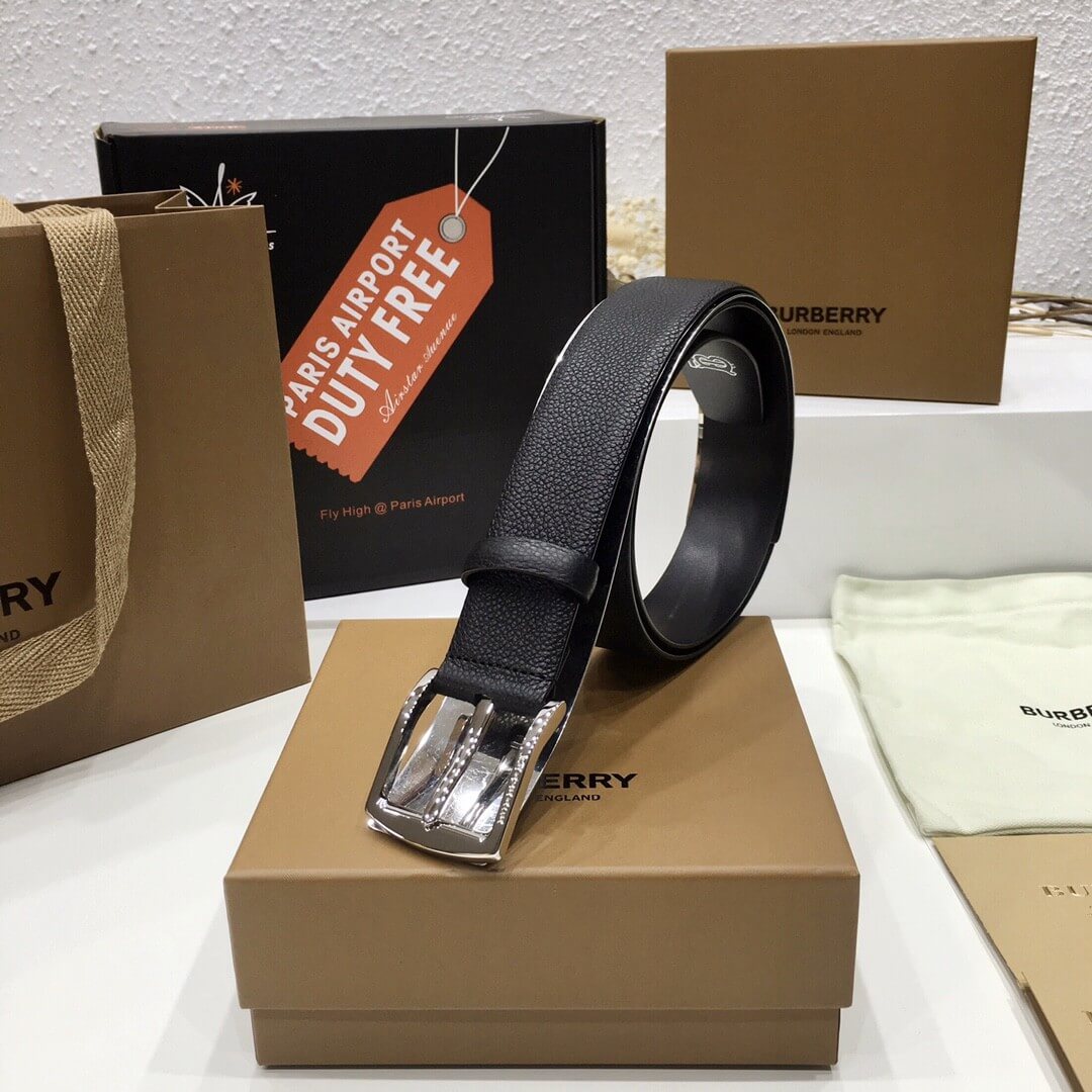 Black belt with silver buckle on a Burberry box with duty free tag in the background