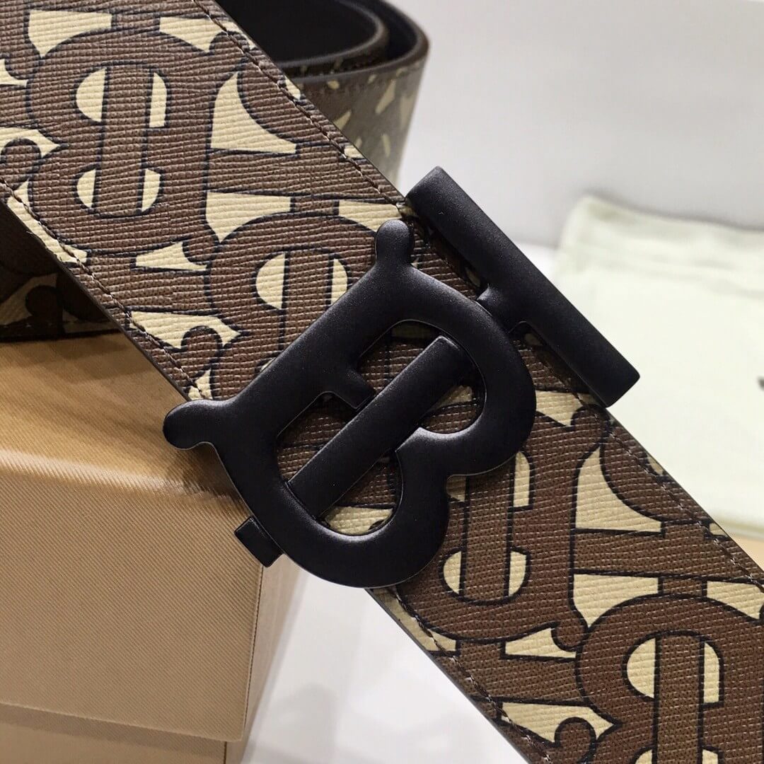 Brown belt with a pattern and black buckle on a white surface