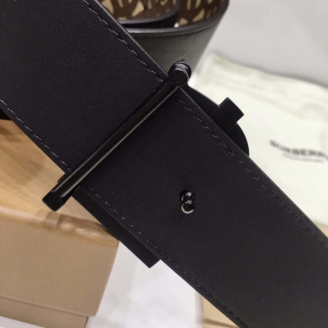 Close-up of a black belt with a buckle on a blurred background
