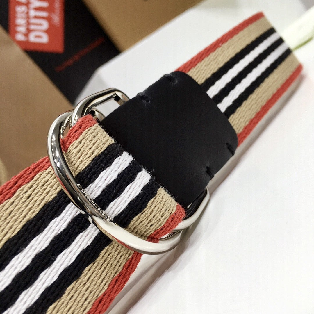 Striped belt with a silver buckle on a white surface
