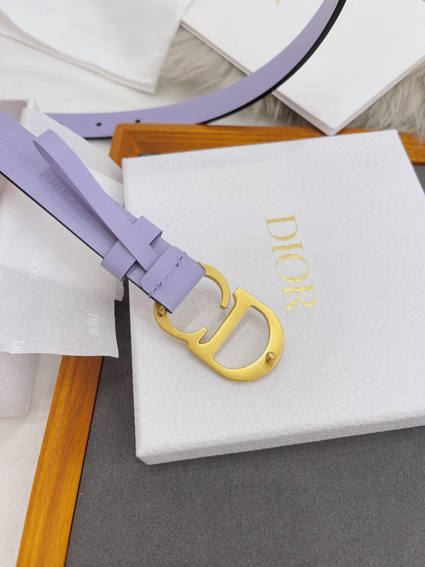 Purple belt with a yellow Dior buckle on a white box