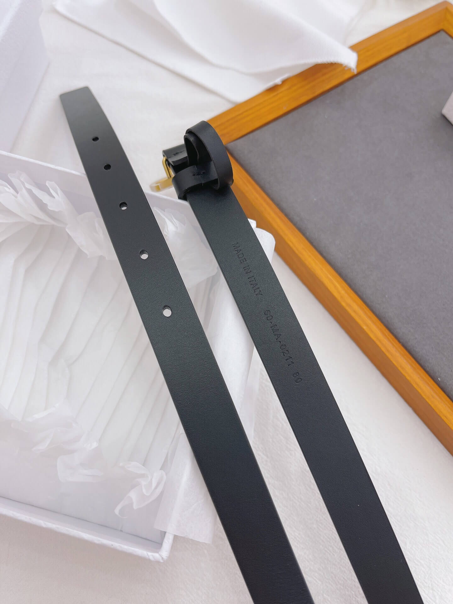 Black metal strip with a plug on a white background