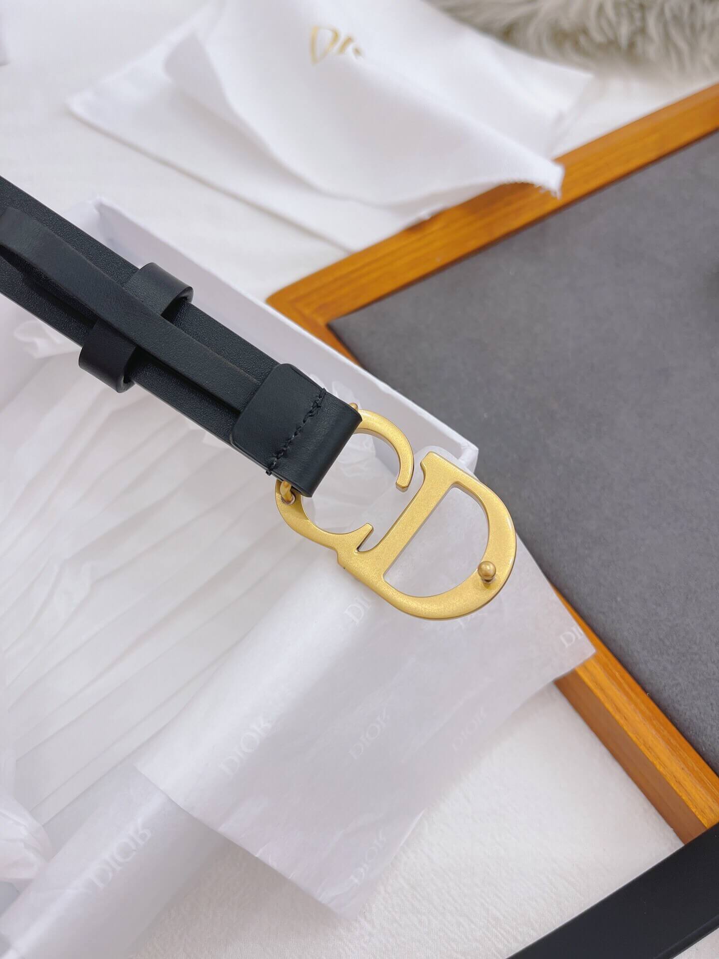Black belt with a gold buckle on a white background