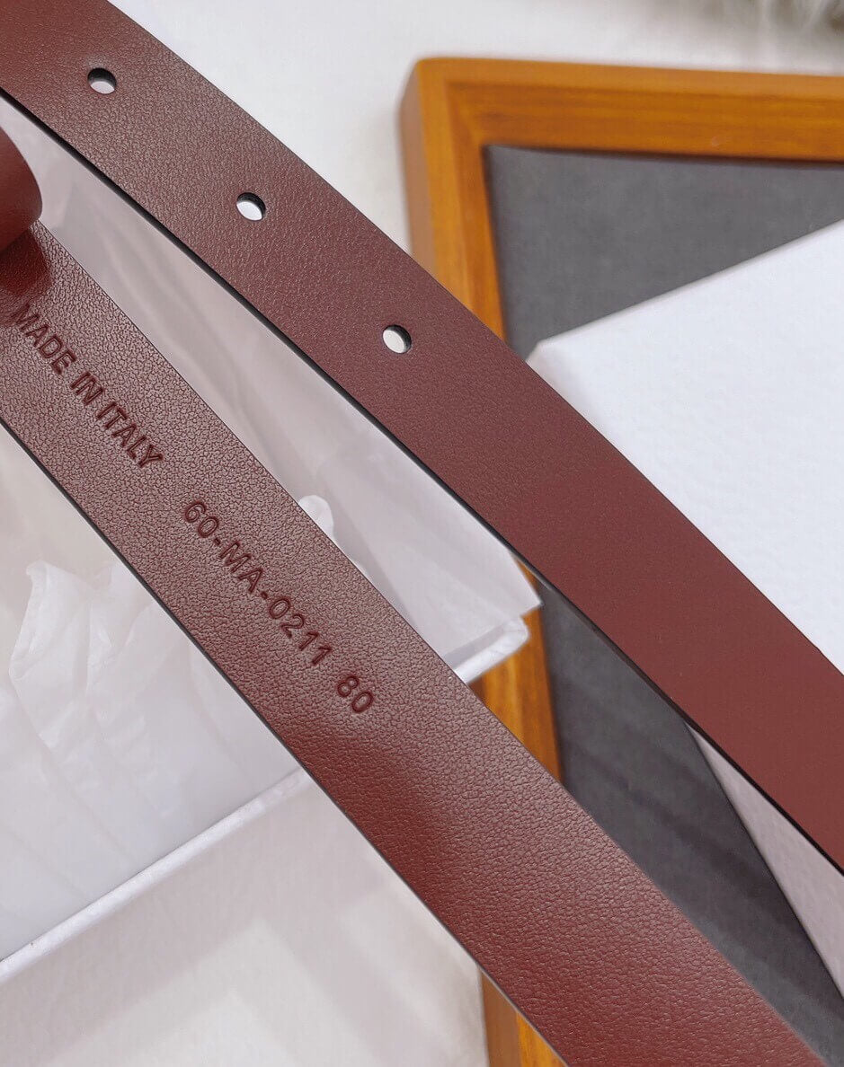 Brown leather belt with 'Made in Italy' stamp on a white surface