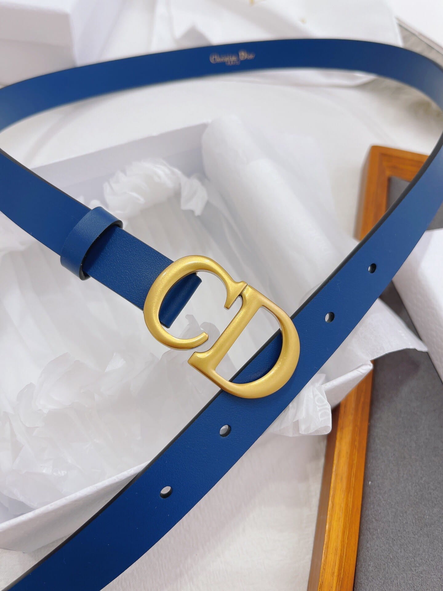 Blue belt with gold logo on a white background
