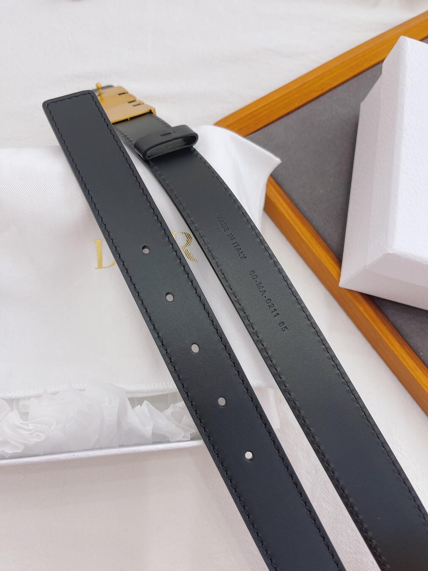 Black belt with gold buckle on a white surface