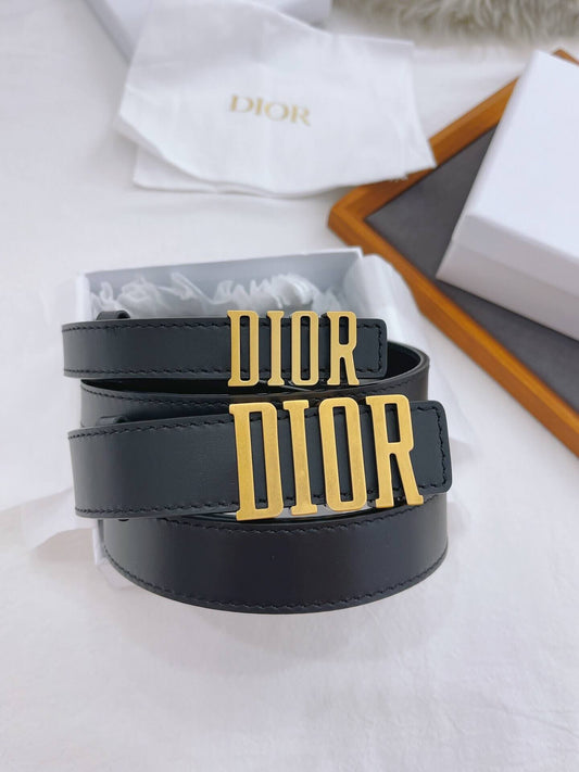 Black Dior belt with gold logo on a white surface