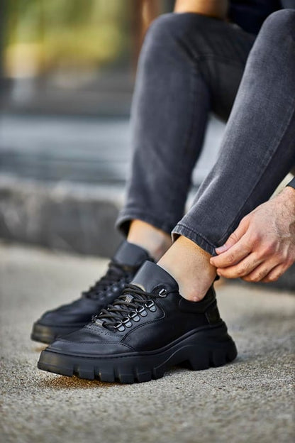 Classic Black Lace Detail Chunky Sneakers - Elegant Leather Footwear for Men – worn by a man in black jeans, showcasing sleek black leather and a chunky sole.