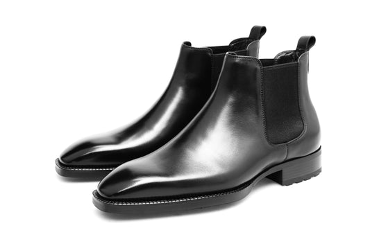 Classic Black Leather Chelsea Boots for Enduring Style – a straight-on shot of the pair of polished black leather boots on a white background.