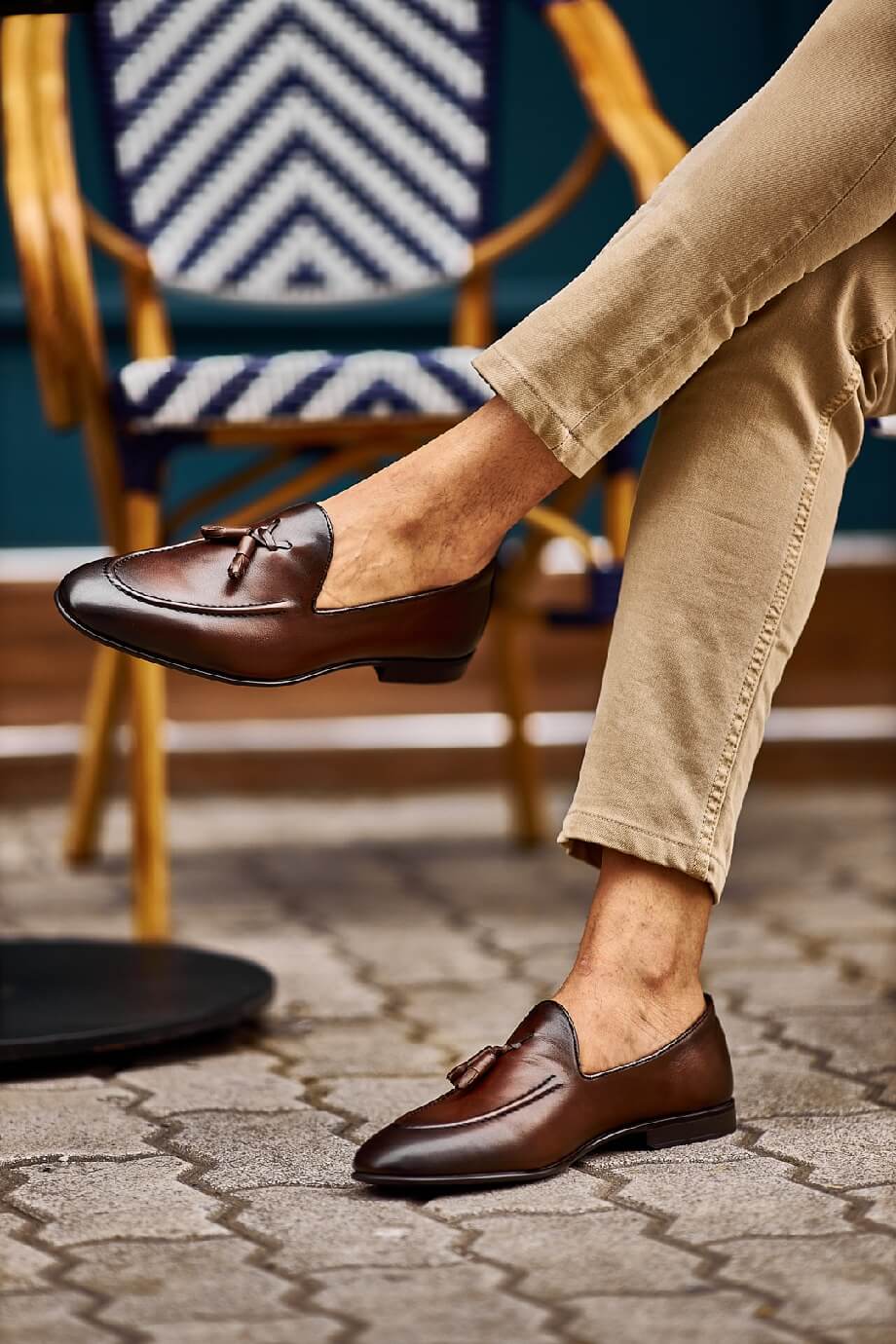 Classic Brown Leather Tassel Loafers for Versatile Style – worn by a man in light cuffed trousers, standing on a paved surface, highlighting timeless elegance and sophisticated design.