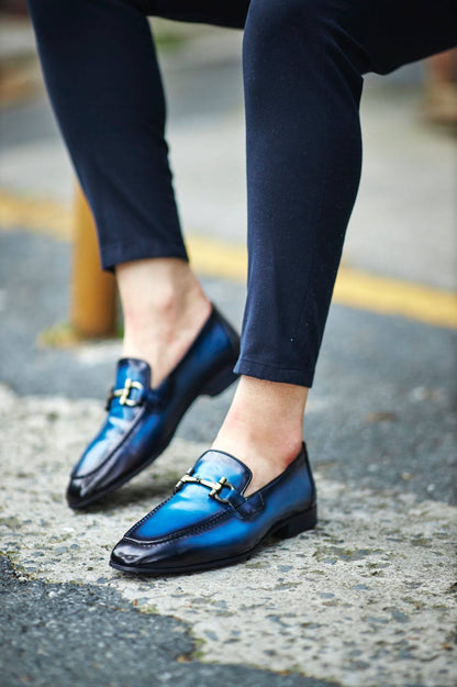 Custer Blue Bit Loafers – Classic Leather Footwear for Every Occasion – worn by a man in dark trousers, highlighting a sleek silhouette, polished finish, and a distinctive horsebit buckle.