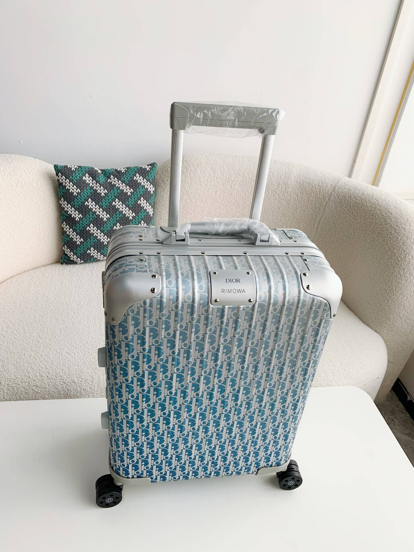 Patterned suitcase on a white surface with a neutral background