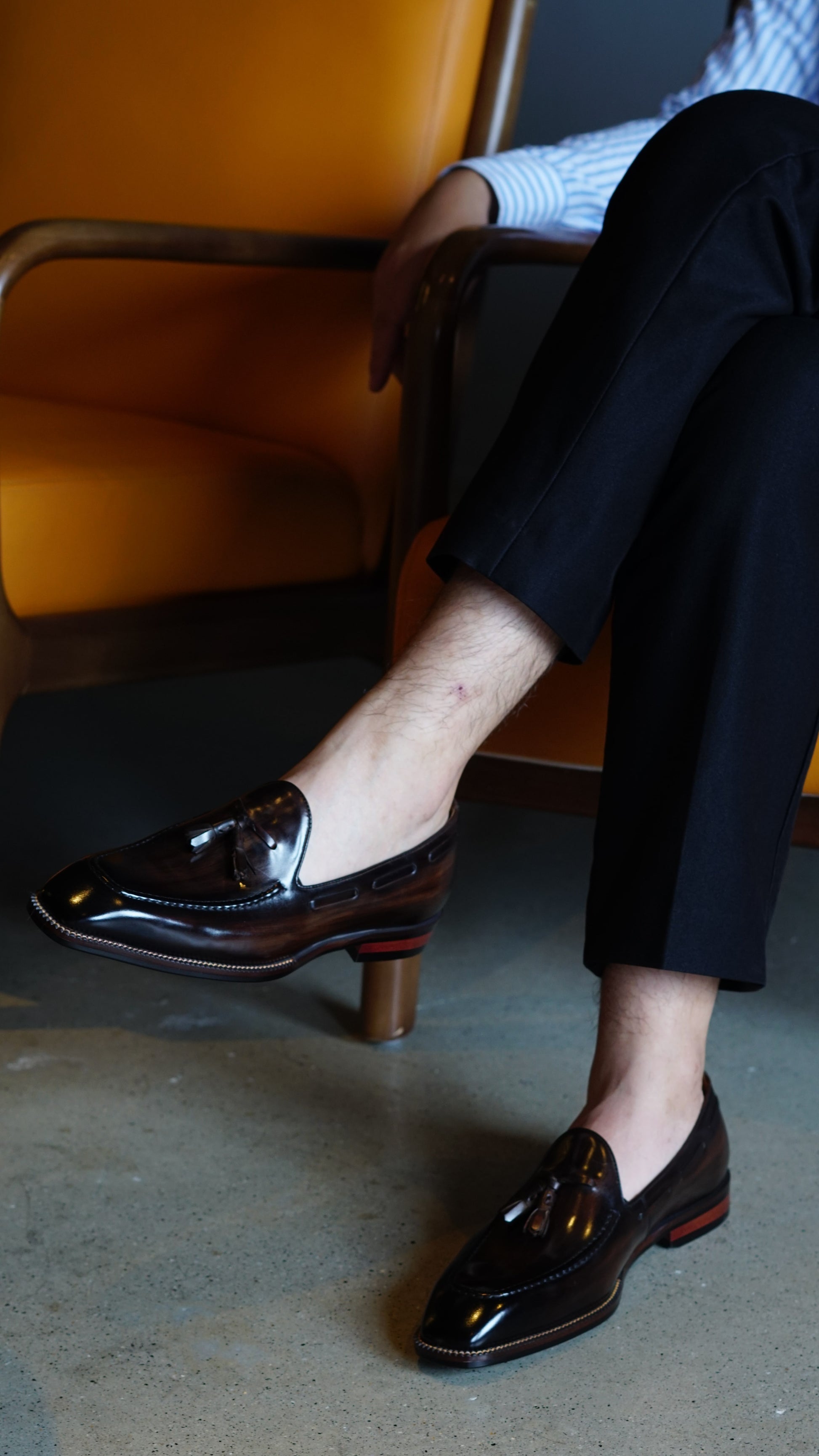 Hand-Made Dark Brown Leather Tassel Loafers – worn by a man in black trousers, showcasing the sleek profile, polished finish, and classic tassel detail.