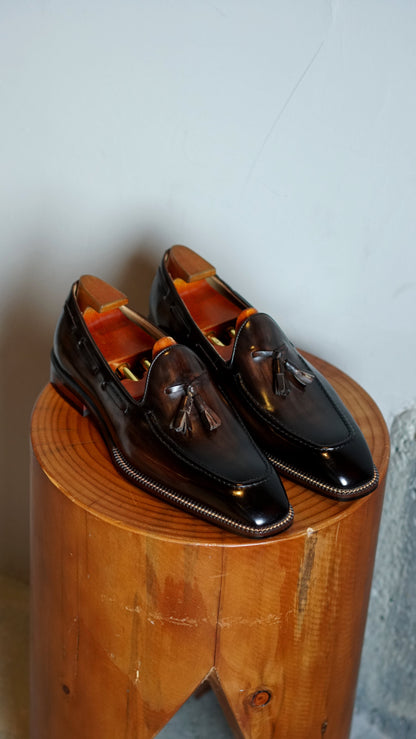 Hand-Made Dark Brown Leather Tassel Loafers – pair with shoe trees on a wooden stump, highlighting the unique hand-painted finish and tassel detail.