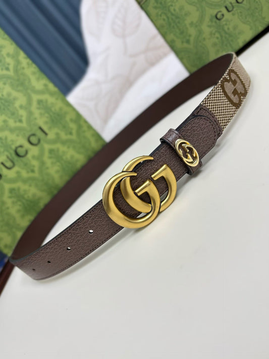 Brown Gucci belt with gold buckle on a white surface