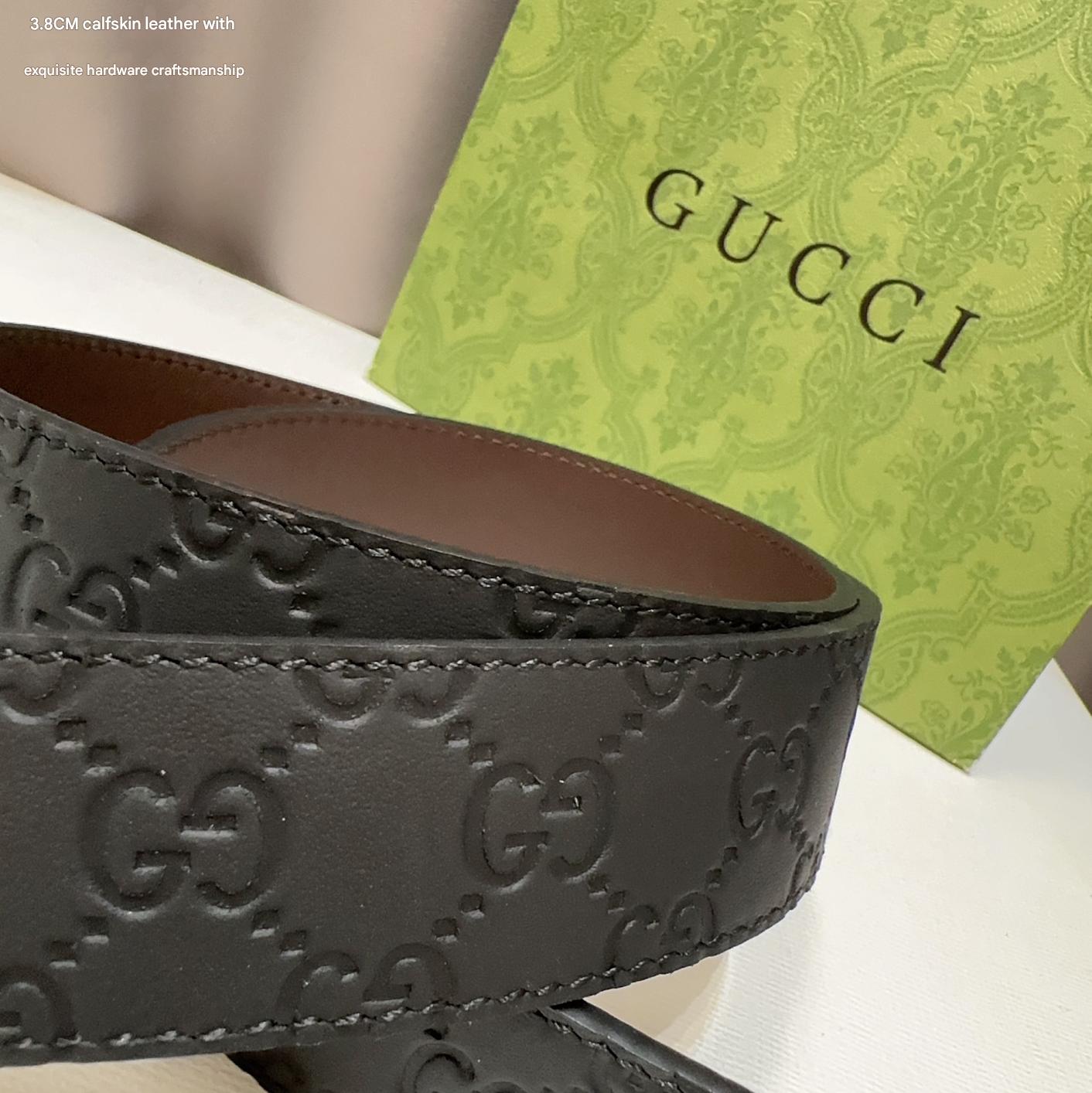 Black Gucci belt with a green box in the background
