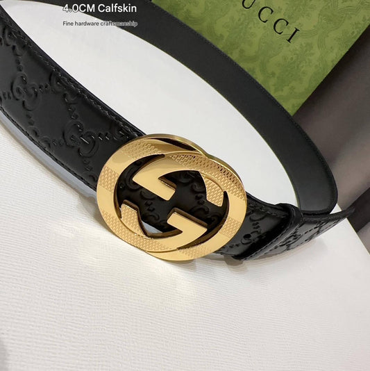 Black Gucci belt with gold interlocking G buckle on a white background