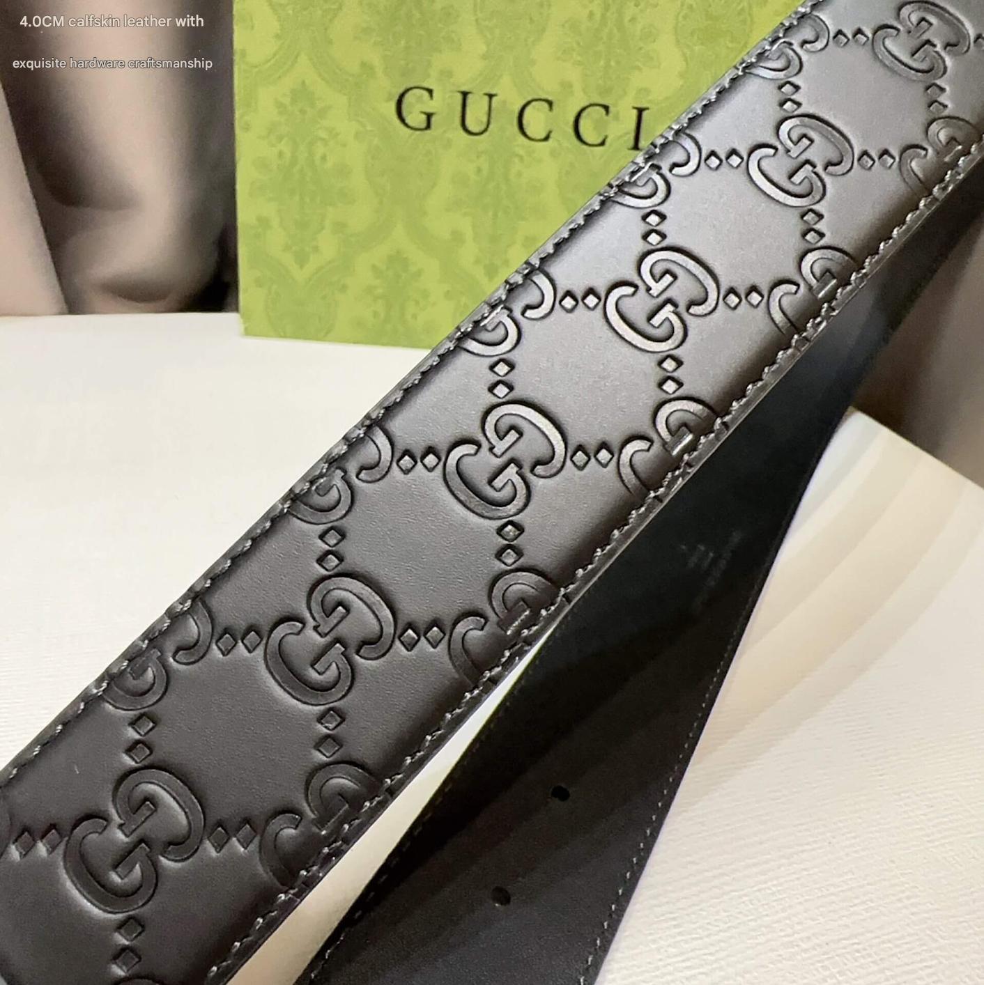 Black leather belt with Gucci logo on a white surface