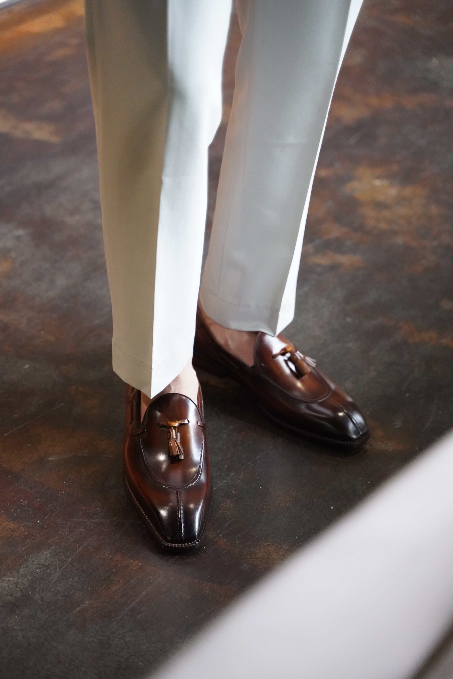 Hand-Burnished Brown Patina Leather Tassel Loafers – worn with light cuffed trousers, showcasing sophisticated style and timeless elegance.